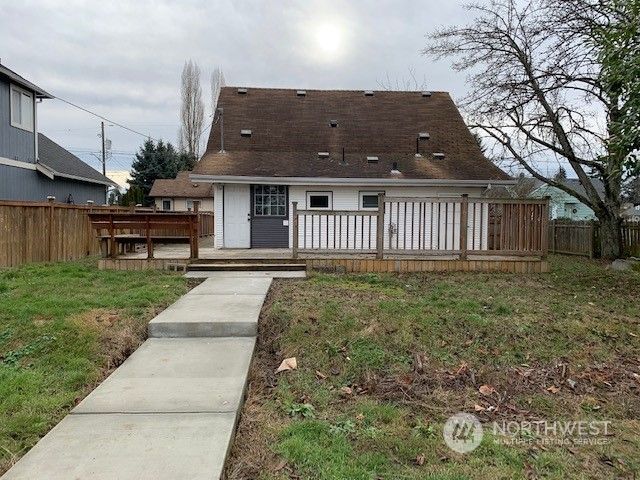 a front view of a house with a wooden deck