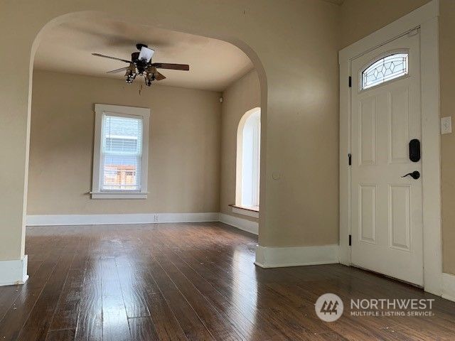 a kitchen with stainless steel appliances wooden floors and wooden cabinets
