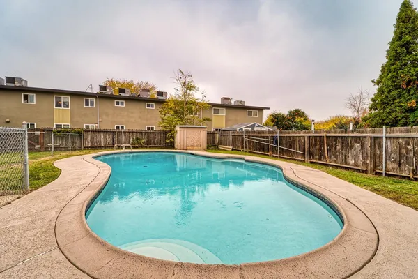 a view of a swimming pool with a lounge chair