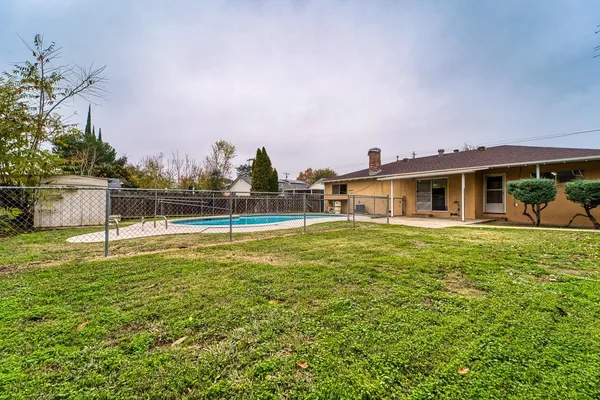 a view of a house with a yard balcony and sitting area