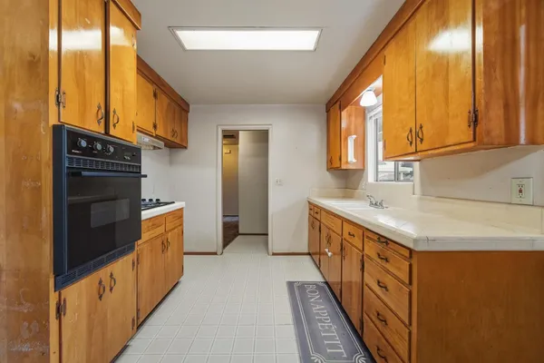 a kitchen with stainless steel appliances a sink and a refrigerator