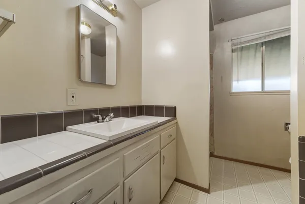 a bathroom with a sink and a mirror