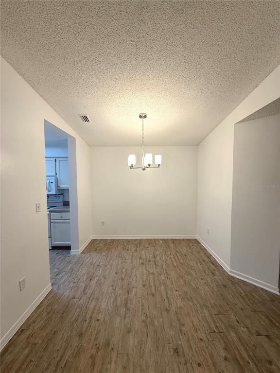 202 Riverbend Drive, Unit 201 Altamonte Springs, FL 32714 - Photo 3 of 13 wooden floor in an empty room with a window
