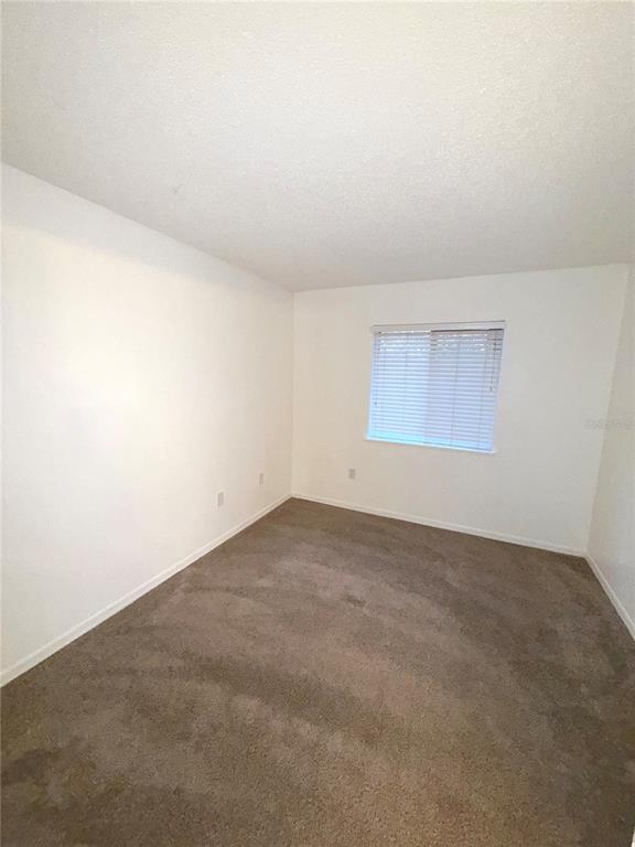 202 Riverbend Drive, Unit 201 Altamonte Springs, FL 32714 - Photo 8 of 13 an empty room with a empty space and window