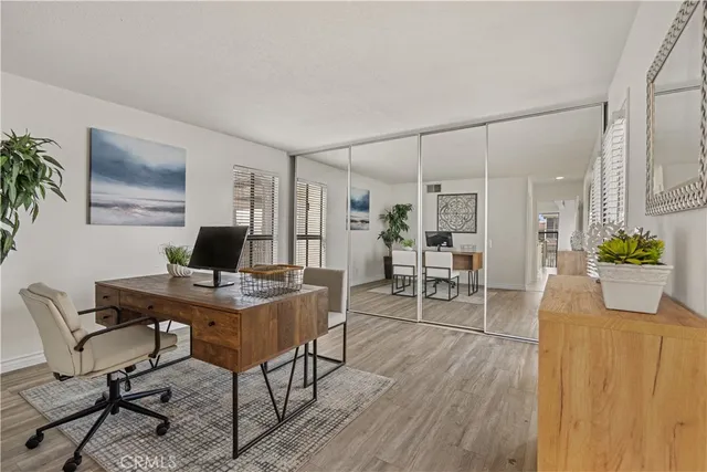 a view of a workspace with furniture and a potted plant