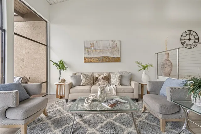 a living room with furniture and a painting on the wall