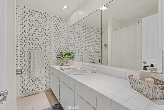 a bathroom with a double vanity sink and a mirror