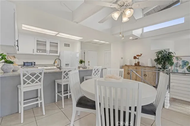 a large kitchen with a table and chairs