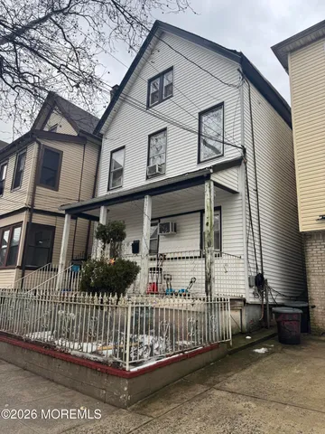a front view of a house with iron fence