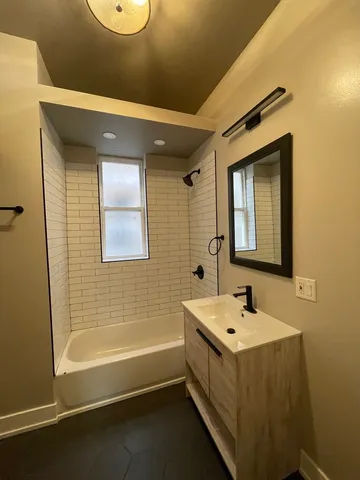 a bathroom with a bathtub and a sink