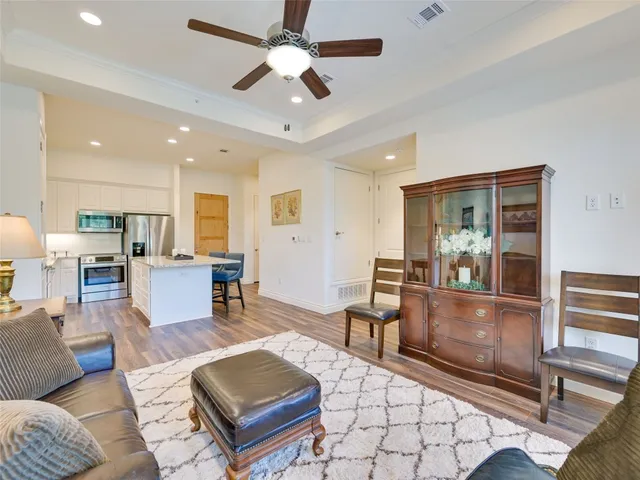 a living room with furniture and a view of kitchen