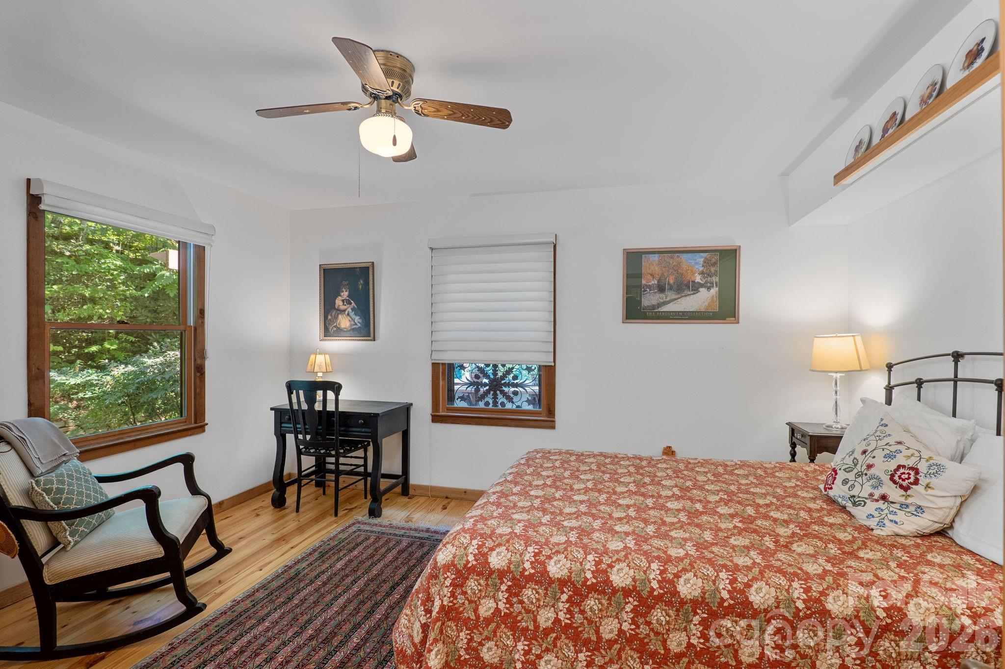 150 Avondale Ridge Road Asheville, NC 28803 - Photo 23 of 45 a bedroom that has a bed and a table in it with window