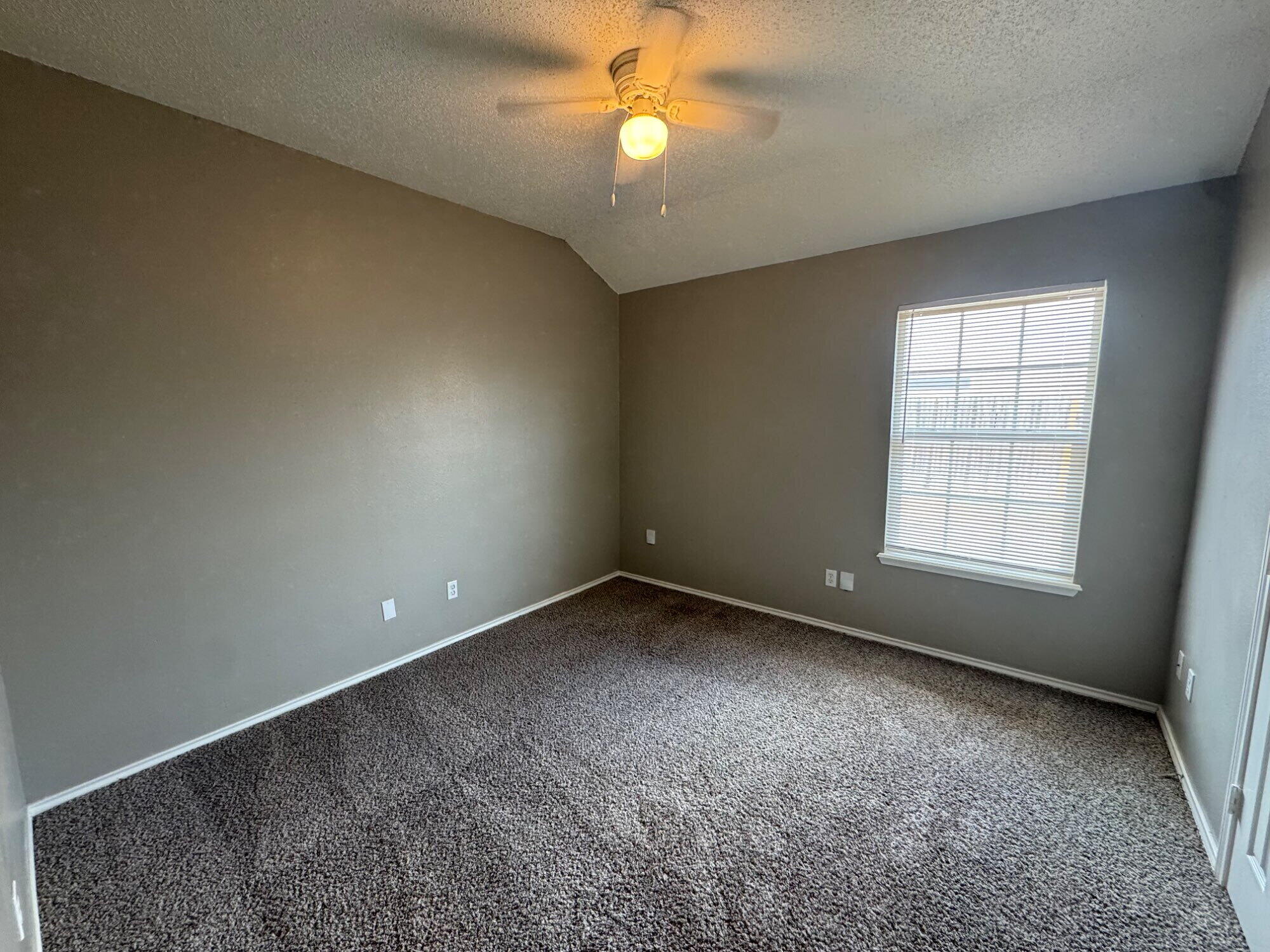 5812 6th Street, Unit A Lubbock, TX 79416 - Photo 4 of 7 an empty room with a window