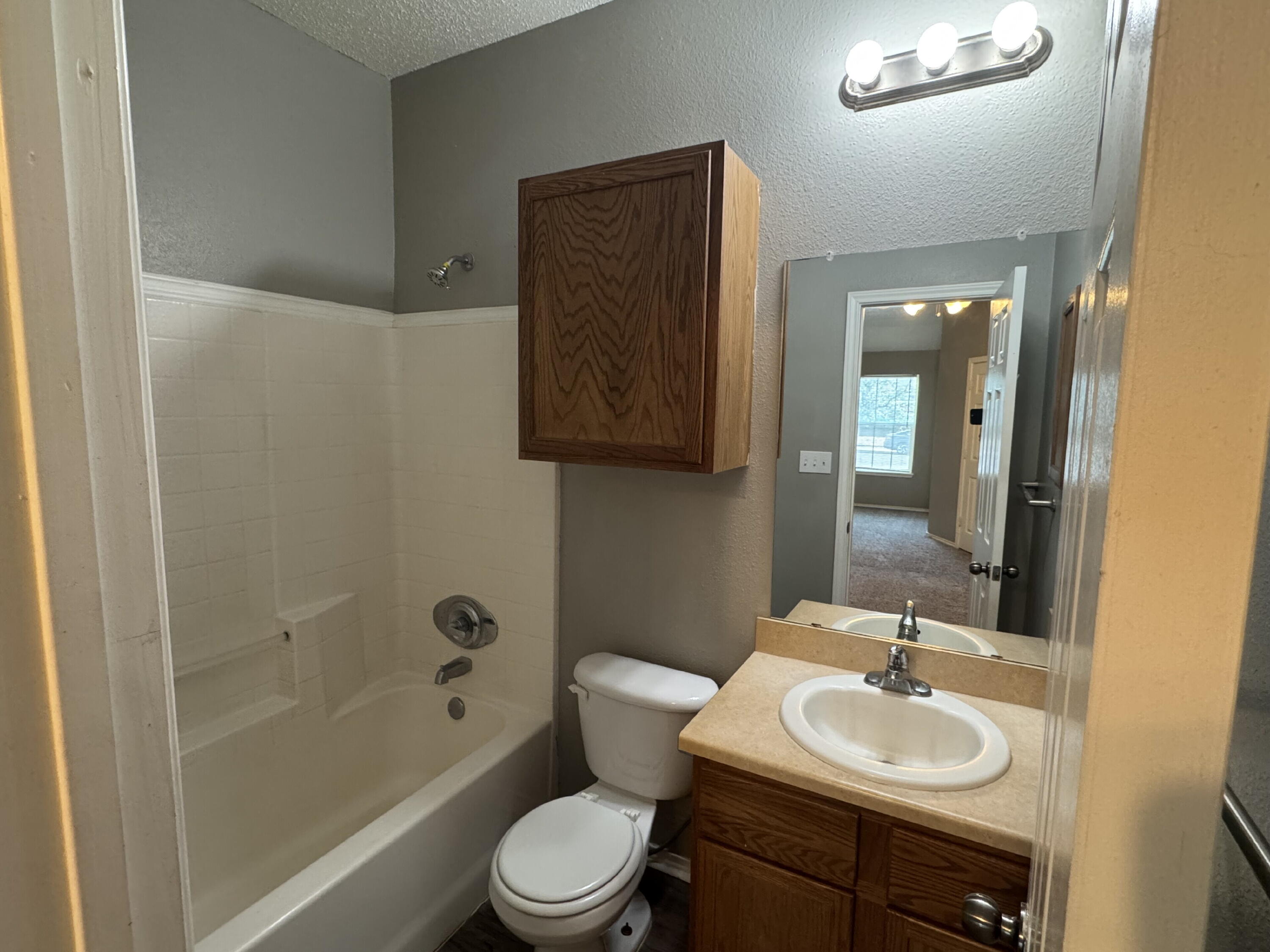 5812 6th Street, Unit A Lubbock, TX 79416 - Photo 7 of 7 a bathroom with a sink toilet and shower