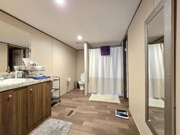 a bedroom with a bed chair and a desk in it