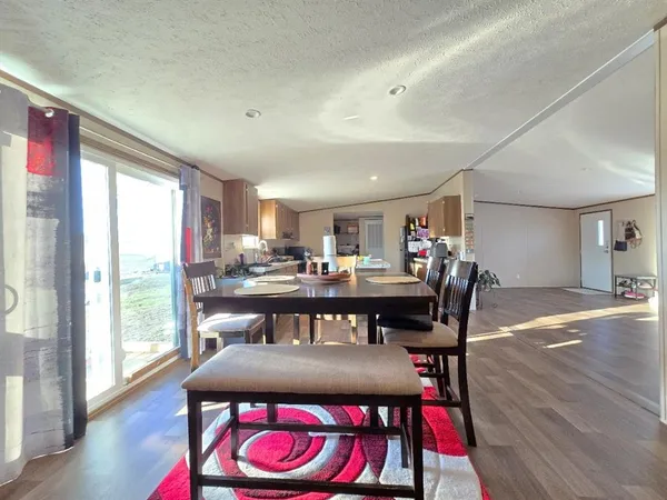 a dining room with furniture window and wooden floor