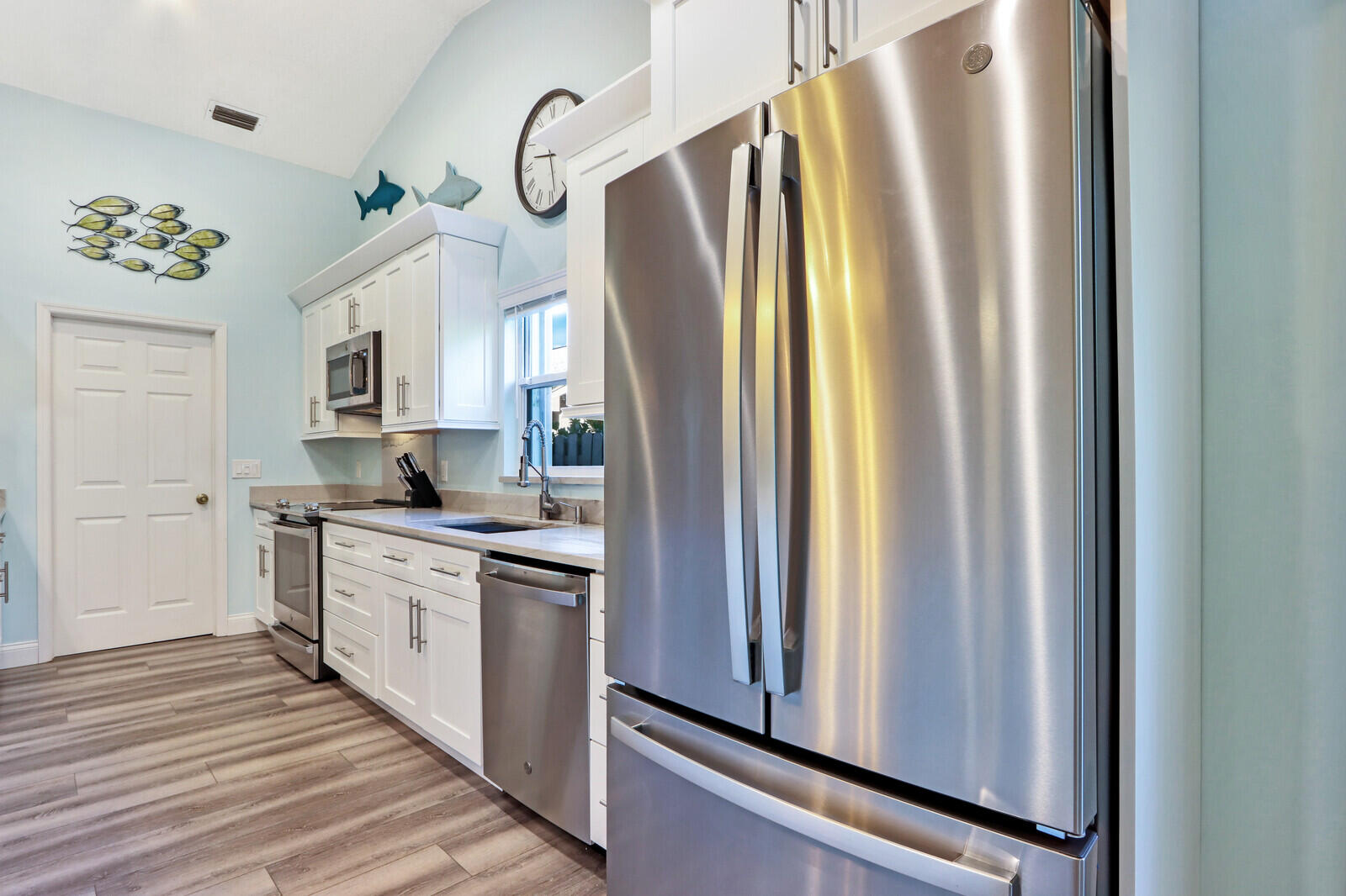 905 Sandy Oaks Drive Jupiter, FL 33477 - Photo 14 of 51 a kitchen with stainless steel appliances a refrigerator sink and cabinets