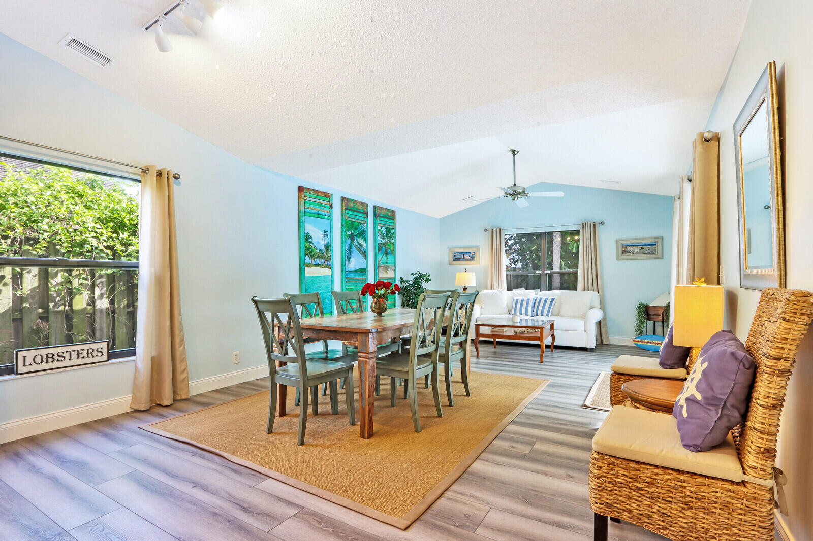 905 Sandy Oaks Drive Jupiter, FL 33477 - Photo 16 of 51 a dining room with wooden floor a chandelier a glass table and chairs
