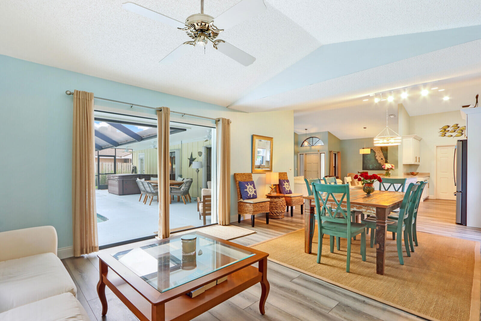 905 Sandy Oaks Drive Jupiter, FL 33477 - Photo 18 of 51 a living room with furniture a table and wooden floor