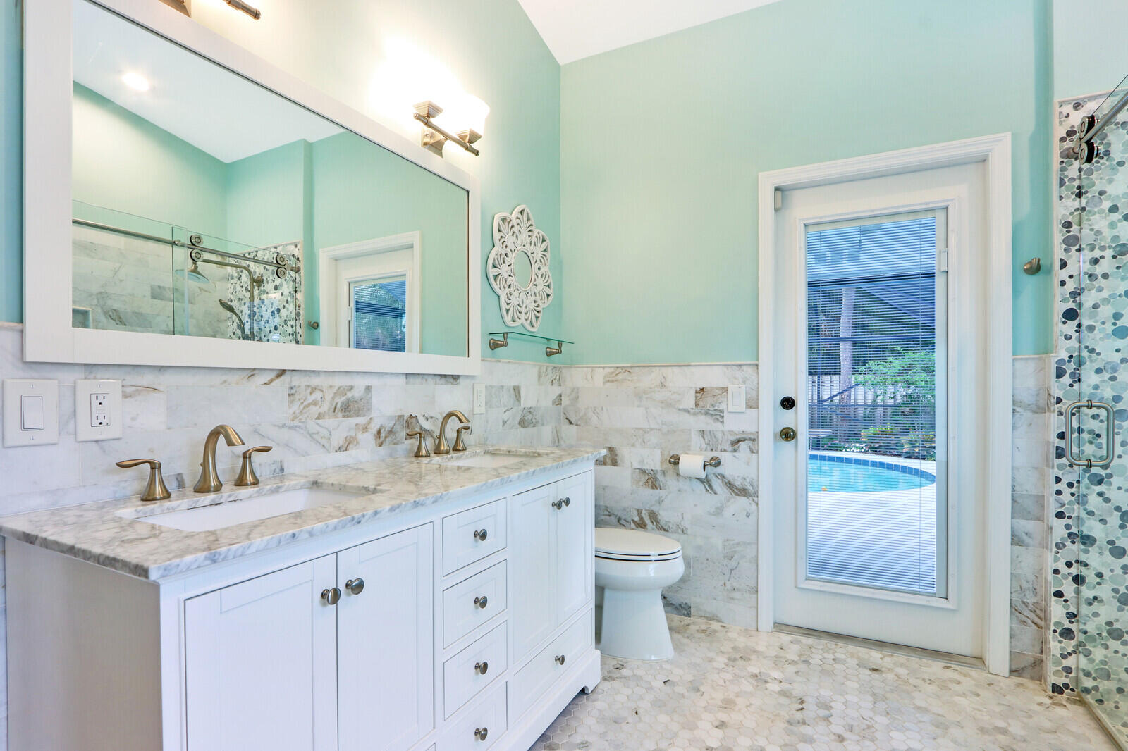 905 Sandy Oaks Drive Jupiter, FL 33477 - Photo 22 of 51 a bathroom with a granite countertop sink a toilet and a mirror