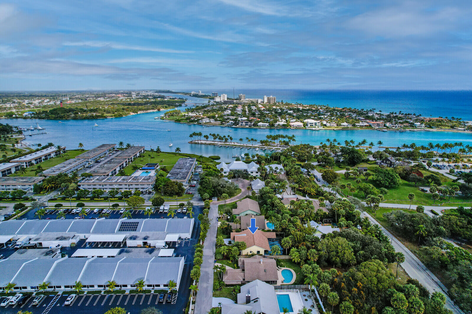 905 Sandy Oaks Drive Jupiter, FL 33477 - Photo 44 of 51 an aerial view of a city with lots of residential buildings and ocean view in back