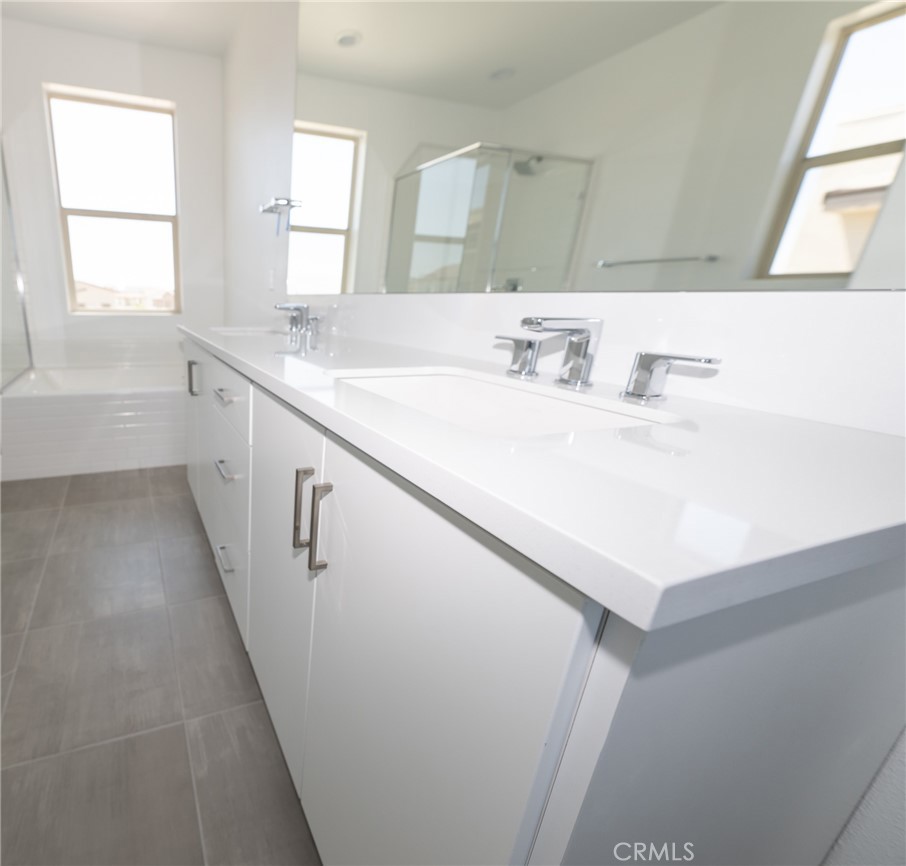 35878 McCarthy Street Palm Desert, CA 92211 - Photo 18 of 26 a bathroom with a sink a mirror and a bathtub