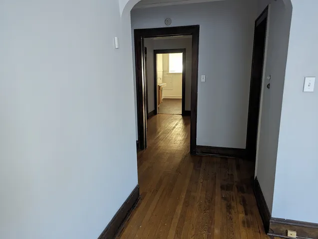 a view of a hallway with wooden floor