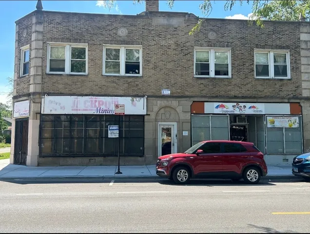 a car parked in front of a brick building