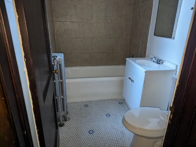 a bathroom with a sink a toilet a tub and shower