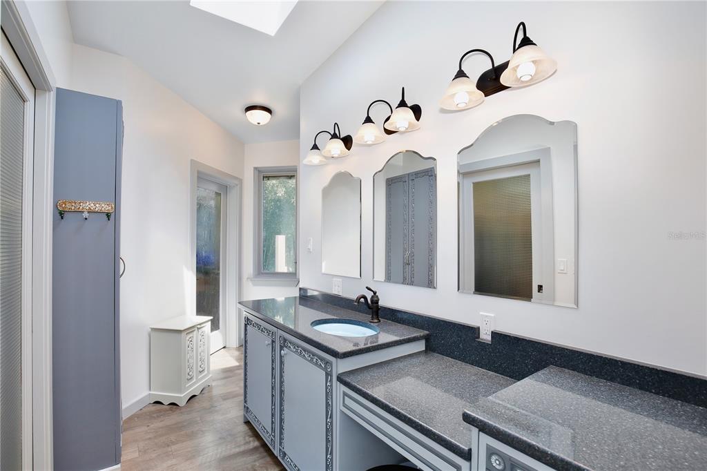 183 Parsons Road Longwood, FL 32779 - Photo 19 of 100 a bathroom with a double vanity sink and a mirror