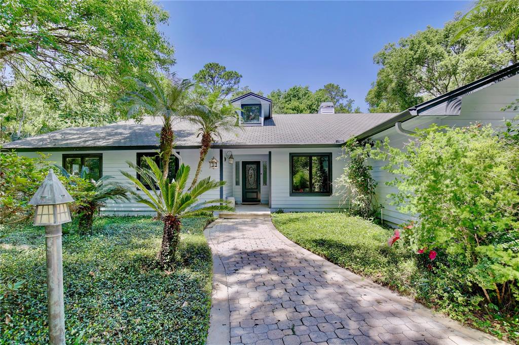 183 Parsons Road Longwood, FL 32779 - Photo 2 of 100 a front view of a house with a garden