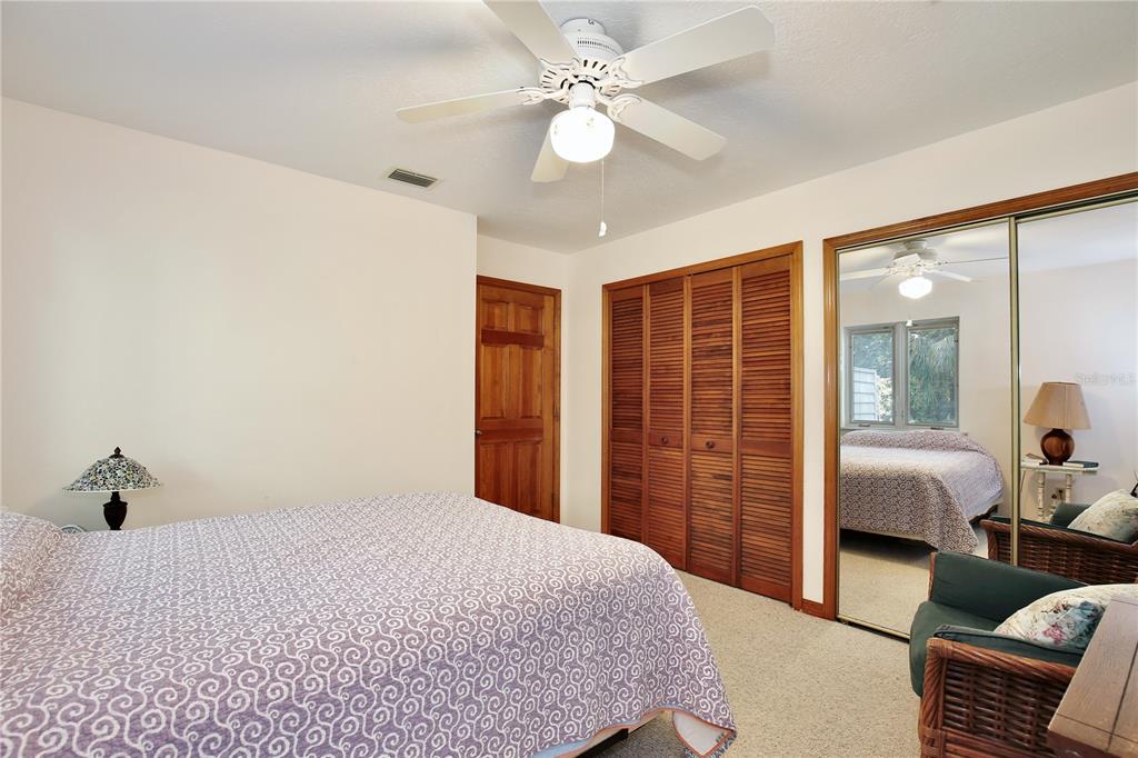 183 Parsons Road Longwood, FL 32779 - Photo 33 of 100 a bedroom with a large bed and a chandelier