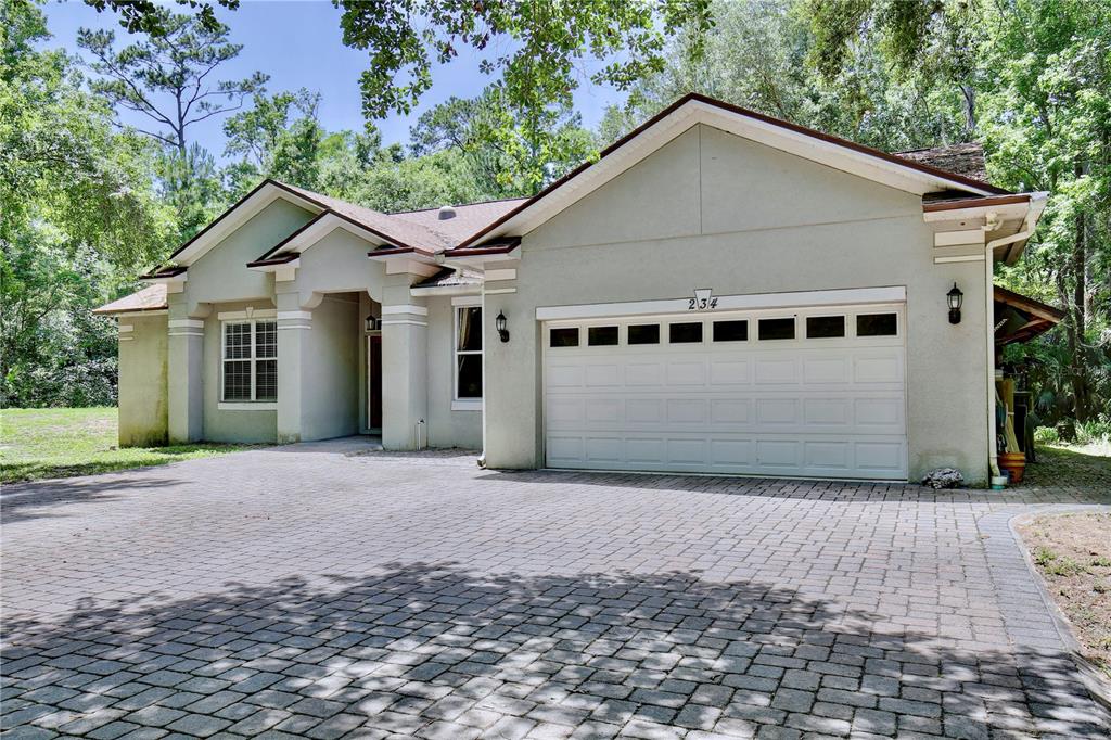 183 Parsons Road Longwood, FL 32779 - Photo 70 of 100 a front view of a house with a yard and garage