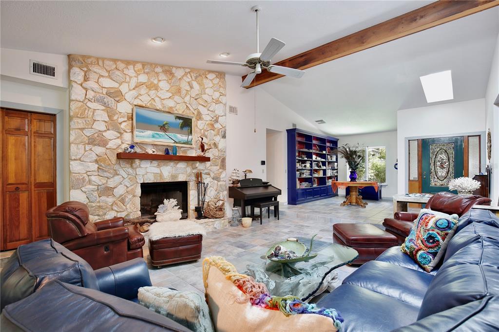 183 Parsons Road Longwood, FL 32779 - Photo 7 of 100 a living room with furniture a fireplace and a flat screen tv