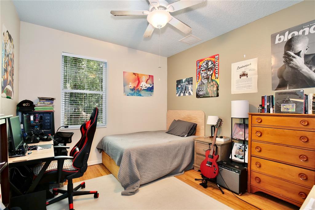 183 Parsons Road Longwood, FL 32779 - Photo 89 of 100 a bedroom with a bed and a bookshelf