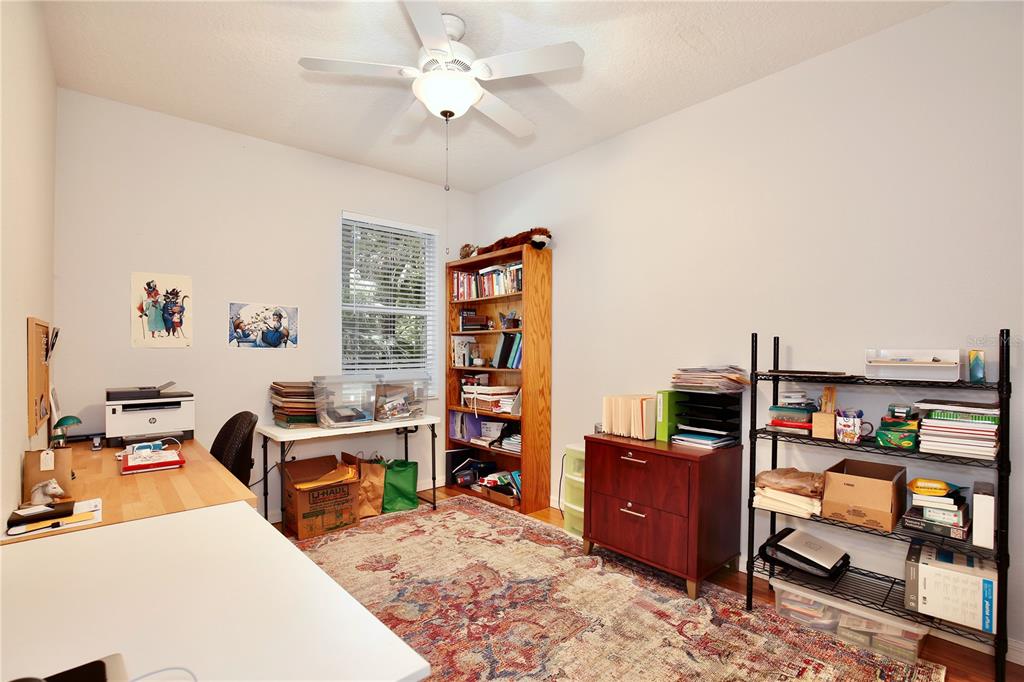 183 Parsons Road Longwood, FL 32779 - Photo 92 of 100 a living room with furniture a flat screen tv and gym equipment