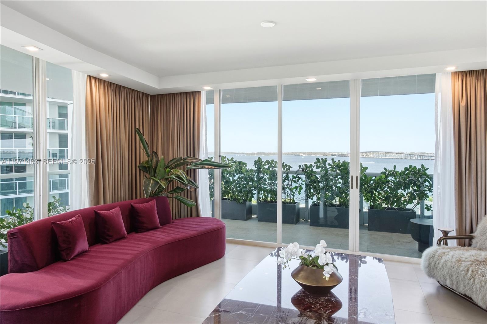 2127 Brickell Avenue, Unit 904 Miami, FL 33129 - Photo 14 of 38 a living room with furniture and a potted plant