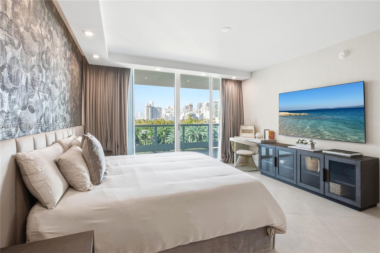 2127 Brickell Avenue, Unit 904 Miami, FL 33129 - Photo 21 of 38 a bedroom with a large bed and a flat tv screen on dresser