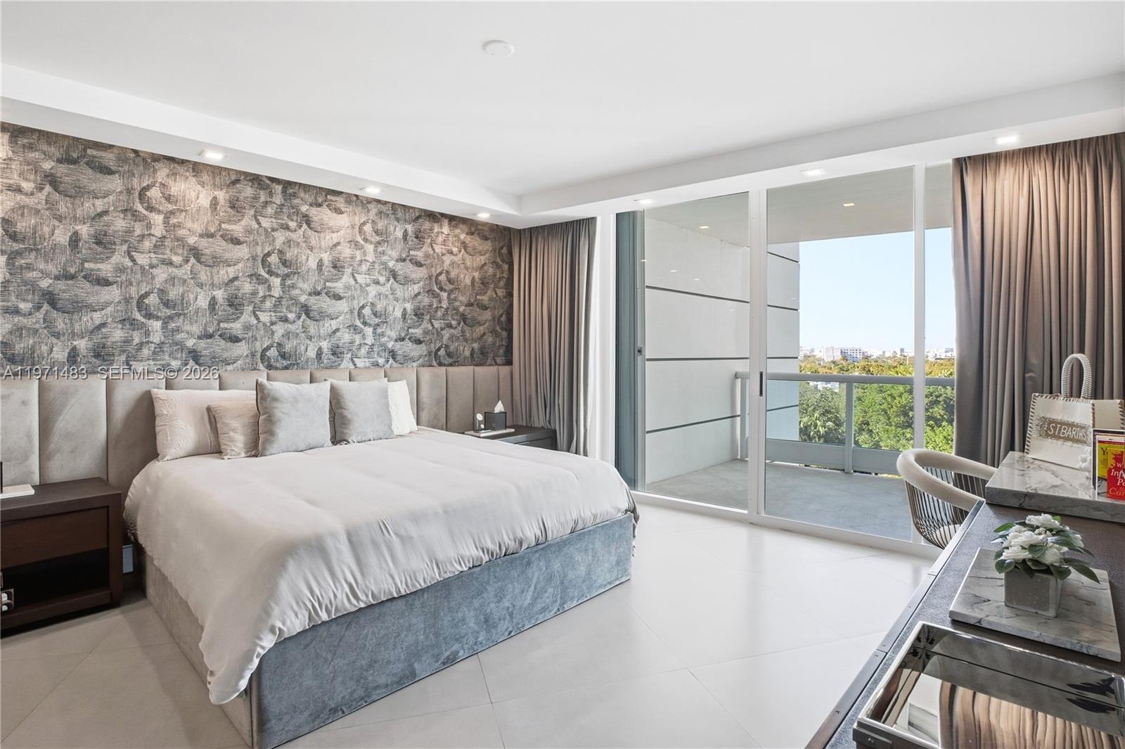 2127 Brickell Avenue, Unit 904 Miami, FL 33129 - Photo 22 of 38 a bedroom with a bed and a large window with garden view