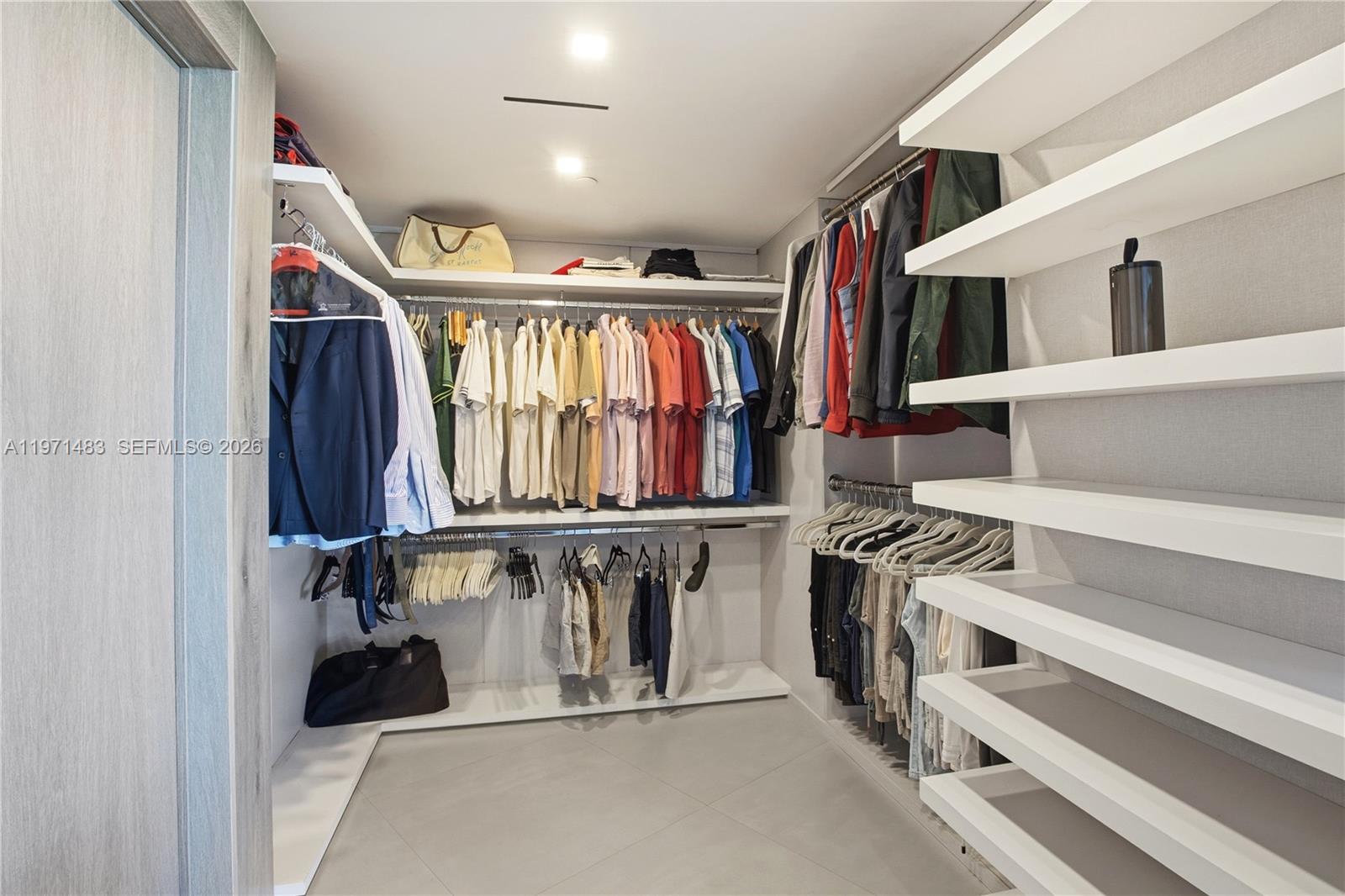 2127 Brickell Avenue, Unit 904 Miami, FL 33129 - Photo 24 of 38 a view of walk in closet with clothes and shoes