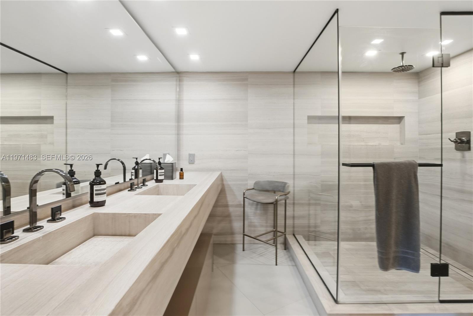 2127 Brickell Avenue, Unit 904 Miami, FL 33129 - Photo 25 of 38 a bathroom with a double vanity sink a toilet and a mirror