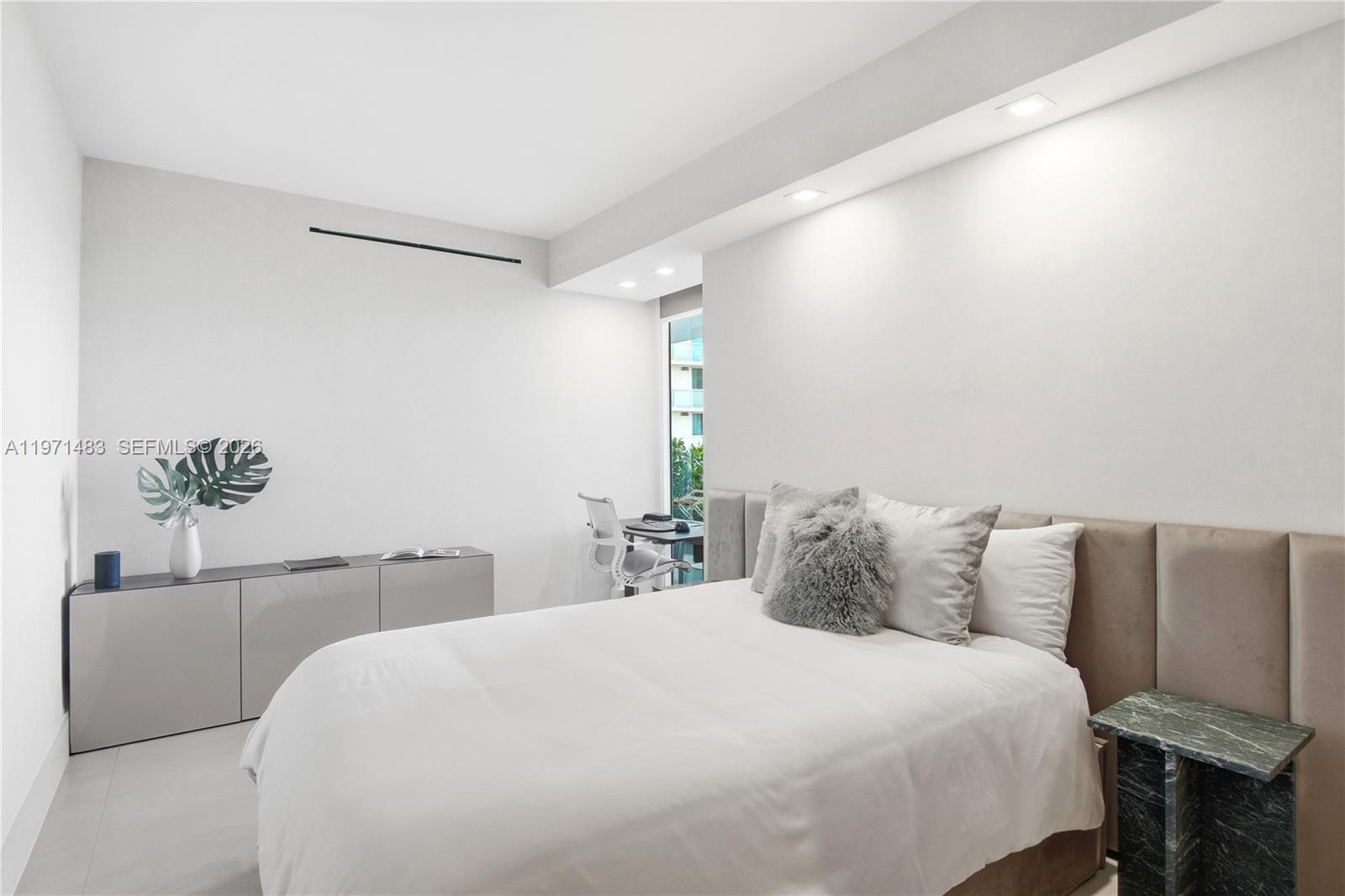 2127 Brickell Avenue, Unit 904 Miami, FL 33129 - Photo 28 of 38 a bedroom with a bed and a potted plant