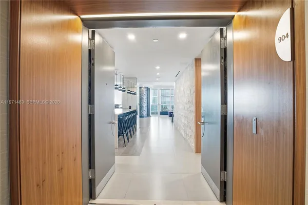 a view of a hallway with a furniture and a mirror
