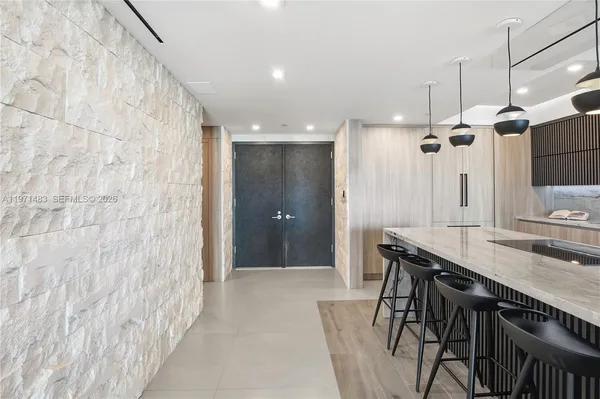a bathroom with a granite countertop sink a mirror and a shower