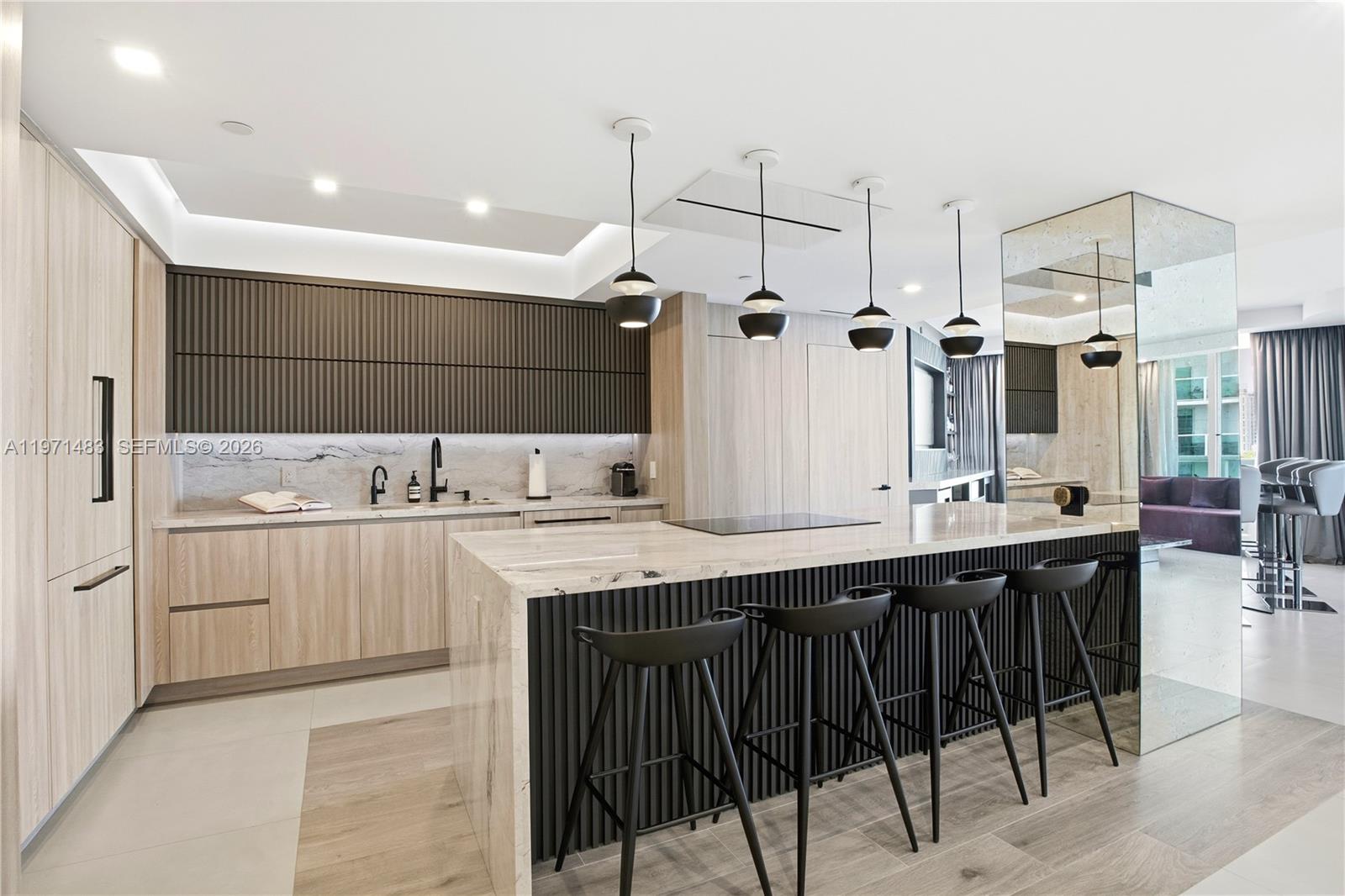 2127 Brickell Avenue, Unit 904 Miami, FL 33129 - Photo 6 of 38 a kitchen with a sink and cabinets