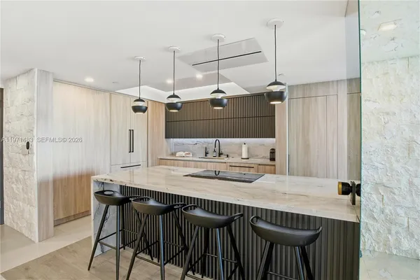 a kitchen with a table chairs refrigerator and microwave
