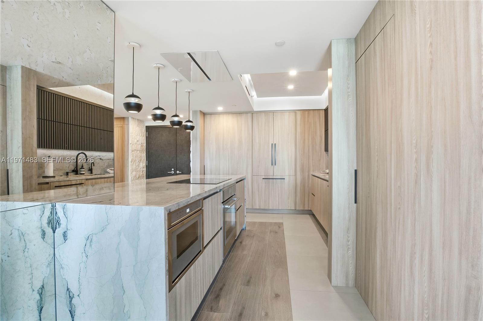 2127 Brickell Avenue, Unit 904 Miami, FL 33129 - Photo 8 of 38 a large kitchen with a large counter top sink and stainless steel appliances