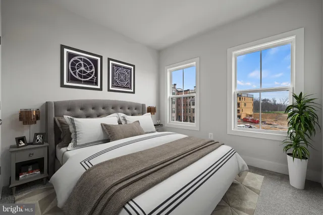 a bedroom with bed and a potted plant