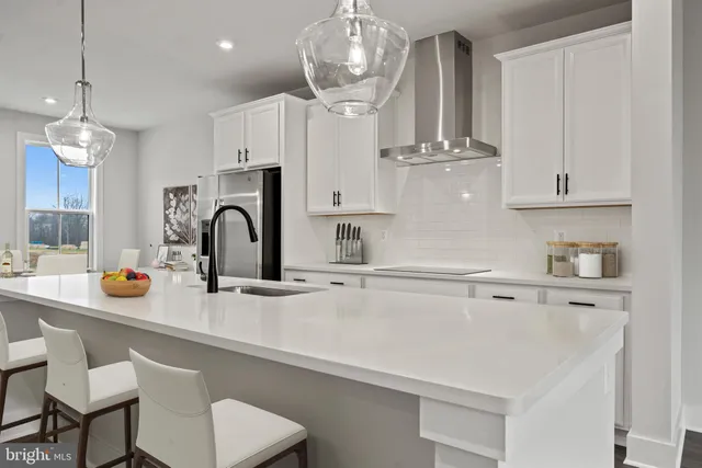 a kitchen with stainless steel appliances a sink and cabinets