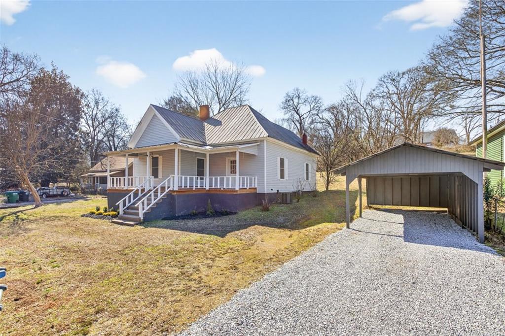 246 Spring Street Commerce, GA 30529 - Photo 2 of 23 a front view of a house with a yard covered in snow